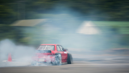 Motion blurred of driving a drift car by a skilled driver and having experience on a speed track © applezoomzoom