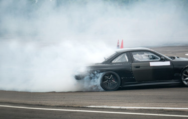 Driving a drift car by a skilled driver and having experience on a speed track © applezoomzoom