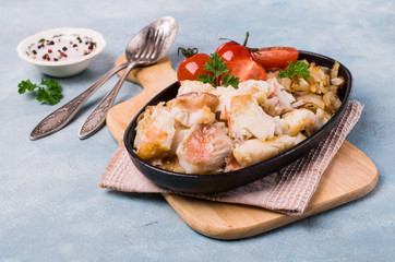 Slices of fried fish with vegetables