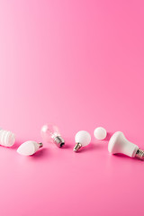 various types of light bulbs on pink background