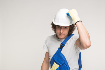 Construction, building and workers concept - Closeup portrait of handsome funny caucasian man in builders helmet.
