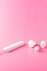 close-up view of socket outlet and various light bulbs on pink