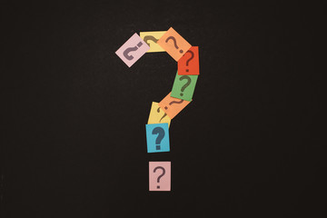 multicolored paper with QUESTION MARK isolated on black background. concept of FAQ, Q&A, questions and problems