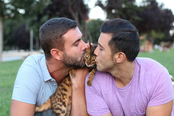 Gay couple in the park with their pet