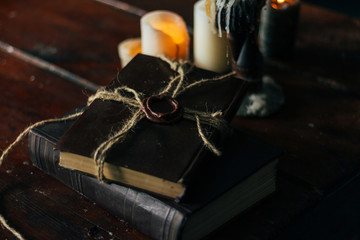old book on a wooden table by candlelight