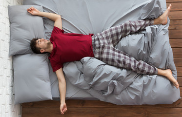 Man sleeping in bed at home