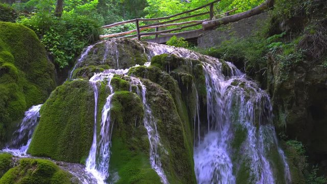 Beautiful unique Bigar Waterfall in Romania on the Edge of the Road passing through the carpatian Mountains