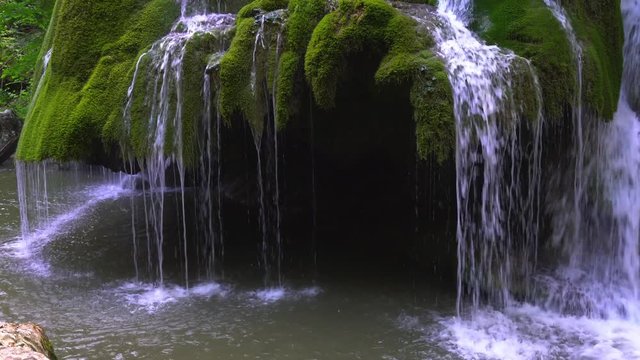 Beautiful unique Bigar Waterfall in Romania on the Edge of the Road passing through the carpatian Mountains