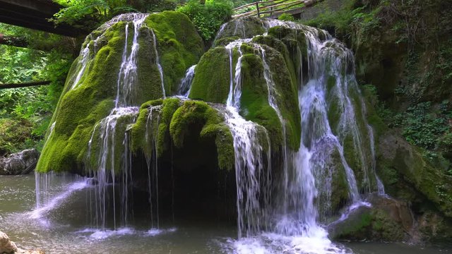 Beautiful unique Bigar Waterfall in Romania on the Edge of the Road passing through the carpatian Mountains
