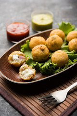 Dahi Ke Angare also known as Kabab or kebab is a popular snack item from India / Pakistan. served with green and red sauce. Selective focus