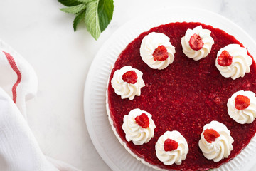 Raspberry cream mousse cake no baked cheesecake on white background. Copy space.