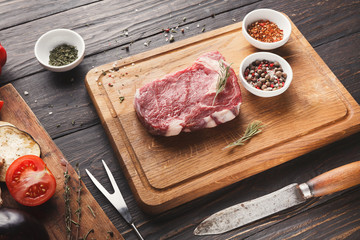 Raw beef filet mignon steak on wooden board