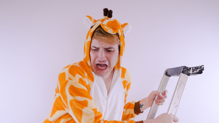 guy in a bright children's pajamas in the form of a kangaroo, on white background. emotional...
