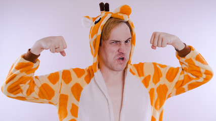 guy in a bright children's pajamas in the form of a kangaroo, on white background. emotional...