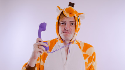 guy in a bright children's pajamas in the form of a kangaroo, on white background. emotional...