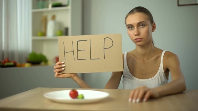 Help word written by depressed anorexic girl, starving body, eating disorder