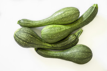 Four isolated zucchini over the white background
