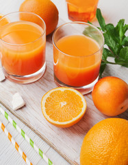 Fresh orange juice with fruits on wooden table