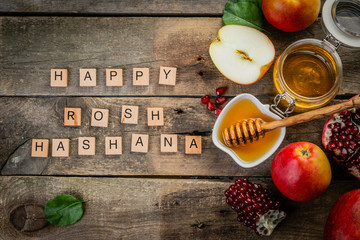 Rosh hashana jewish holiday concept - apples, honey, pomegranate