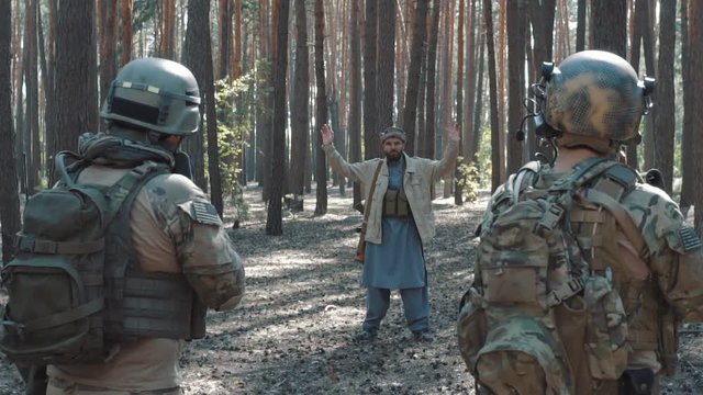 Soldiers of the US Army take prisoner Mujahideen in the forest