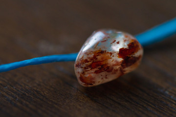 Macro of a stone and a thread 