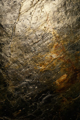Stone texture background with gold metallic tones