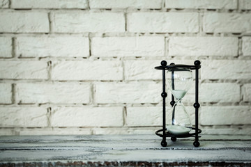 a hourglass on a brick background