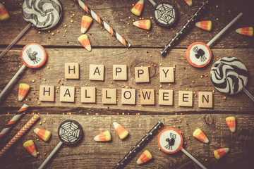 Halloween background - candies and lollipops, straws, wood background