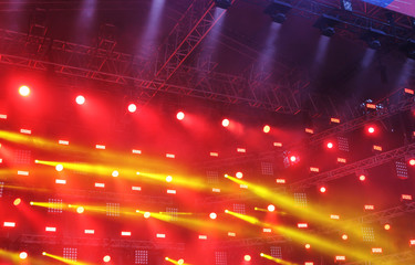 Theatrical scene in the beams of red and yellow spotlights