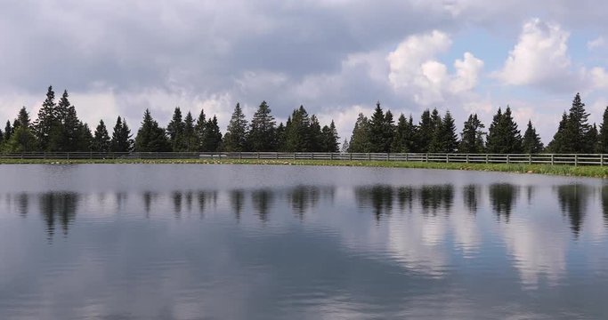 Beautiful sunny lake with trees. Rogla, Slovenia.
