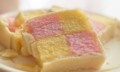 Close up of Battenberg cake B, light sponge cake with the pieces covered in jam, shallow depth of field food photography
