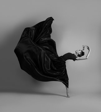 Ballerina in a flying black dress