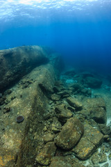 Beautiful underwater scenery and rock formations in a shallow, clear, tropical ocean