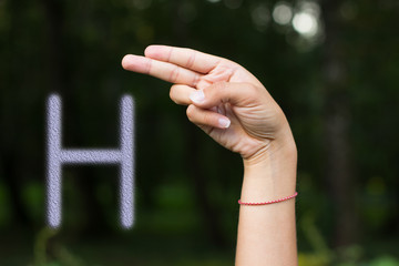 signs and symbols for people with disabilities concept of dactyl international alphabet by female hand and fingers with letter 