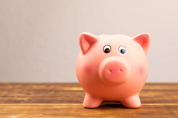 pink piggy bank on wooden background