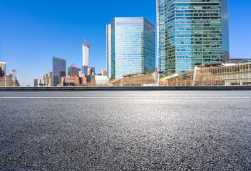 city skyline with empty asphalt road in urban