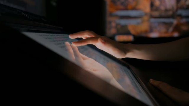 Woman using interactive touchscreen display at modern history museum. Education and technology concept