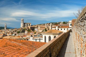 Naklejka premium Girona skyline from the medieval city walls, Catalonia, Spain. Towers of cathedral and basilica. Aerial view
