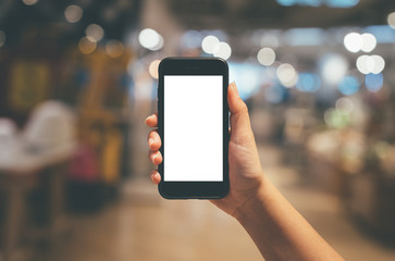 Woman hand holding mobile smart phone isolated white screen at night time with circle bokeh light