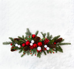 Christmas decoration. Twigs christmas tree, christmas balls, cones spruce and red berries on snow with space for text. Top view, flat lay