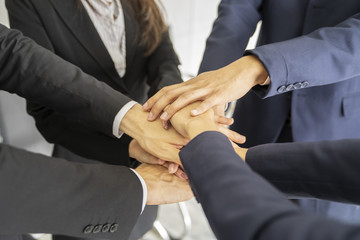 Close up view of young business people putting their hands together like stack.Good coorperat,unity,teamwork concept.