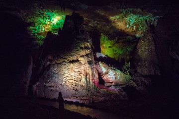 high influx in the karst cave with green illumination