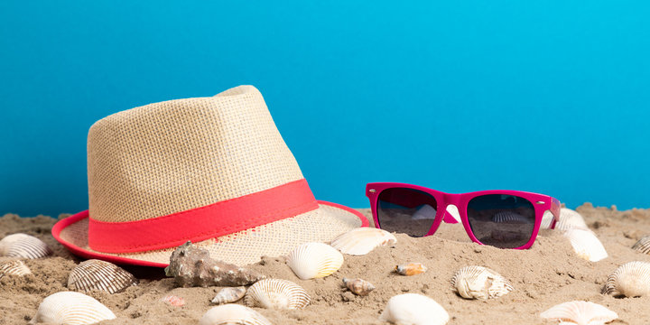 strand hat, sunglasses and shell for holiday