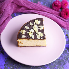 pieces of cheesecake with chocolate on a pink plate, close up