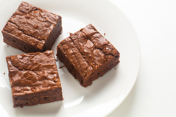 Homemade organic fudge and crispy brownies on white plate