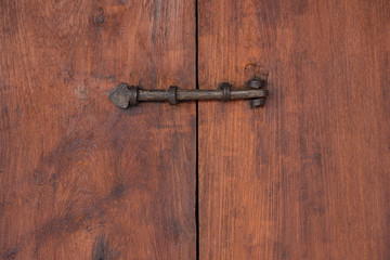Vintage bolt latch on old wooden door