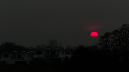 Amazing red moon over polish country landscape.