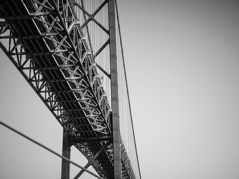 Fototapeta 25 de Abril Bridge, Lisboa, Portugal. Black and white abstract detail from under the 2km landmark suspension bridge over the Tagus River, Lisbon.