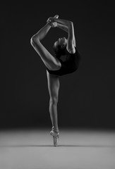 Ballerina in leotard. Black and white photo.