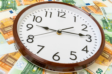 Obraz na płótnie Canvas Clock and Euro currency banknotes